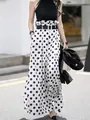 Stylish high-waisted polka dot wide-leg trousers styled with a black halter neck top - S / Bottoms / White