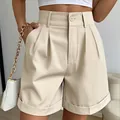 Close-up detail of cream high-waisted wide-leg summer shorts with pleats and side pockets - M / Bottoms / Apricot