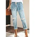 Women's light wash distressed straight-leg jeans with elastic drawstring waist on model. - S / Bottoms / Light Blue