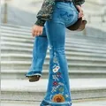 Close-up of women's slim flare jeans with vibrant floral embroidery on side panel - 3XL / Bottoms / Light Blue (6122)