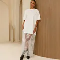 Chic oversized white t-shirt dress with elegant sheer lace patchwork detail - S / White