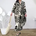 Detail view of bohemian maxi dress with black and white geometric print and tiered skirt - S / Tops / Black