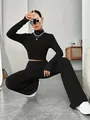 Fashionable black ribbed knit set with crop top and wide-leg trousers on model - S / Top And Bottom / Black
