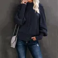 Detail of navy blue cable knit sweater featuring chunky lantern sleeves and a high neck - Navy Blue