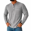Detailed view of men's grey waffle-knit Henley shirt with button neck and chest pocket - S / Tops / Light Gray
