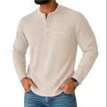 Close-up of men's beige waffle knit Henley shirt with long sleeves and chest pocket - S / Tops / Khaki