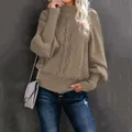 Detailed view of khaki cable-knit sweater with elegant lantern sleeves and high neck. - S / Tops / Khaki