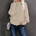 Detailed view of an elegant beige cable knit sweater with stylish lantern sleeves - Apricot