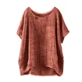 Detail view of reddish-brown loose linen top for women with a chest pocket and round neck. - Tan
