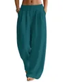 Close-up of loose linen wide-leg trousers in teal with elastic waist and pockets - Malachite green