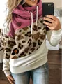 Mirror selfie showing a color block leopard print cowl neck hoodie with drawstrings. - 3XL / Tops / Apricot Leopard + Rose Red