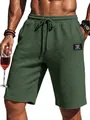 Close-up of men's green waffle texture casual shorts with elastic drawstring waist. - Army Green
