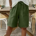 Close-up of green cotton linen shorts for women with drawstring and loose casual fit - Army Green