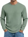 Gros plan sur la texture en maille gaufrée d'un sweat-shirt à manches longues vert - Vert clair