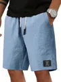 Vista dettagliata dei pantaloncini casual da uomo in maglia a nido d'ape blu con etichetta - Taglia M / Pantaloni e gonne / Celeste