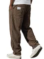 Detailed view of brown corduroy trousers featuring a back pocket patch and white sneakers - Coffee