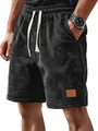 Close-up of men's black grid casual shorts featuring a cream drawstring and leather patch detail - S / Bottoms / Black
