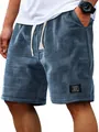 Macro view of blue waffle knit texture on men's casual shorts with patch detail - M / Bottoms / Navy Blue