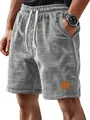 Detail view of men's casual grey plaid shorts featuring drawstring and leather patch. - S / Bottoms / Gray