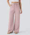 Detailed view of dusty pink wide-leg linen pants with drawstring and side pockets. - S / Bottoms / Lotus Pink