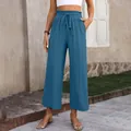 Detailed view of women's blue high-waisted wide-leg cotton linen trousers on model - Dark Blue