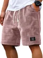 Close-up of mauve waffle knit men's casual shorts featuring drawstring and black patch - M / Bottoms / Lotus Pink