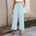Detail view of light blue high-waisted wide-leg cotton linen trousers. - Light Blue