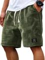 Close-up detail of olive green waffle knit shorts with a classic style patch tag - M / Bottoms / Army Green