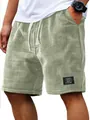 Detail view of men's sage green waffle knit shorts with drawstring and woven patch - 3XL / Bottoms / Light Green