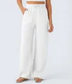 Detail of high-waisted white linen wide-leg pants with adjustable drawstring waist. - White