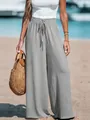 Detailed view of gray cotton linen wide-leg trousers with drawstring waist on beach - Gray