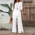 Elegant white women's two-piece set featuring irregular hem top and button pants - White