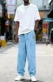 Full view of light blue men's corduroy drawstring pants in a casual street setting. - S / Light Blue