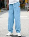 Close-up of men's blue corduroy pants with drawstring and loose fit for casual street style wear. - S / Bottoms / Sky Blue