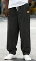 Close-up view of men's dark gray corduroy drawstring loose fit casual trousers for autumn wear - S / Bottoms / Black