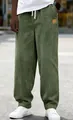 Detailed texture of men's green corduroy drawstring casual trousers in loose fit style. - S / Bottoms / Army Green