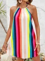 Detail view of a vibrant rainbow-striped halter neck mini dress worn by a model outdoors - S / Top And Bottom / Rainbow Stripe