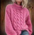 Detailed view of women's pink high-neck cable knit chunky sweater with soft knit - S / Tops / Peach