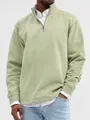 Close-up of sage green men's quarter-zip sweatshirt with stand collar detail - Light Green