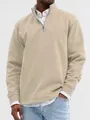 High-quality close-up of a men's beige quarter-zip sweatshirt with a stand-up collar. - Khaki