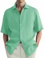 Close-up detail of a light green washed cotton casual short sleeve shirt for men - M / Tops / Light Green