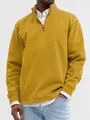 Detailed view of a mustard yellow men's half-zip stand collar sweatshirt on model - Yellow