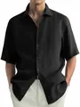 Detailed shot of a black washed cotton short-sleeved shirt with a button-down closure. - M / Tops / Black