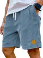 Detail view showing texture of blue corduroy shorts with thick stripes and leather patch - S / Bottoms / Sky Blue