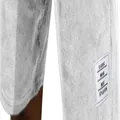 Close-up detail of the white classic wear label on textured corduroy casual men's shorts. - White
