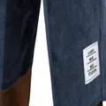 Detail view of blue corduroy shorts featuring a classic white stitched label patch. - Navy Blue