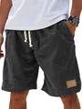 Detailed view of men's faux linen drawstring shorts with leather patch and side pocket - S / Bottoms / Black