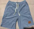 Light blue wide-wale corduroy drawstring shorts with a stylish brown leather patch detail - Light Blue