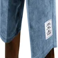 Close-up of light blue corduroy men's shorts with classic white fabric tag on leg hem. - Sky Blue