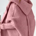 Close-up detail of a pink hooded knitted cardigan featuring batwing sleeves and soft texture - S / Tops / Pink